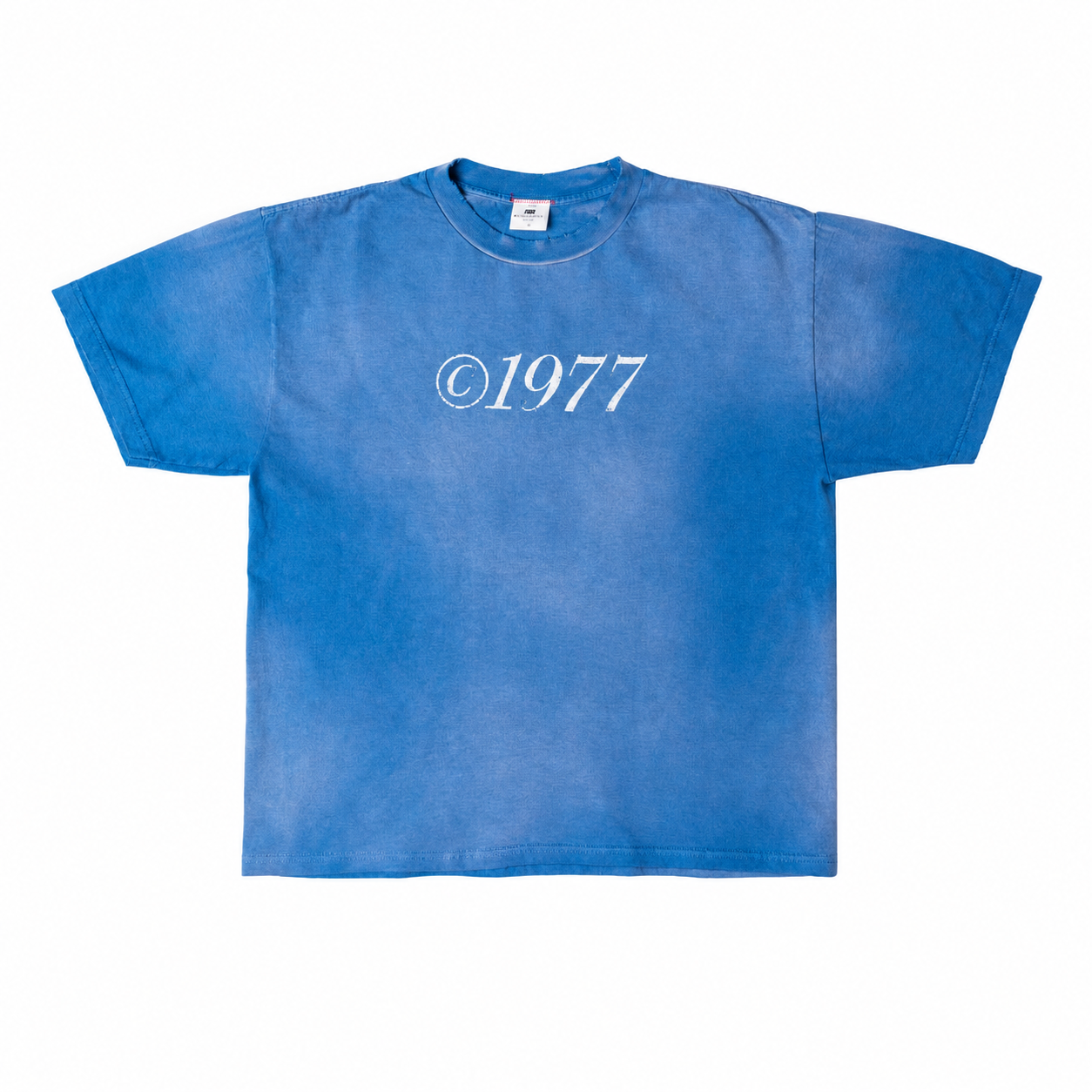 Washed blue tee with a faded white ©1977 chest print